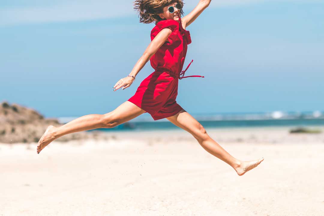 A woman is happily jumping and enjoying her better life after spent time to learn about NLP. This is an example to help NLP draws back the negative criticisms from public.