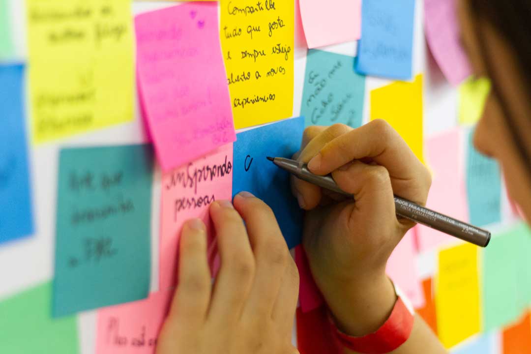 A woman writing on sticky notes